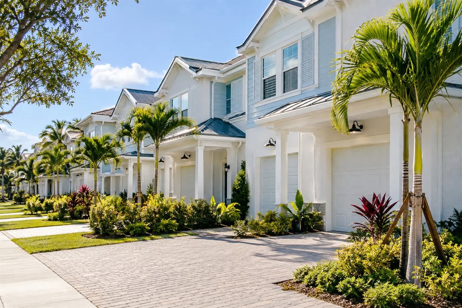 Row of townhomes with garages and landscaped front yards